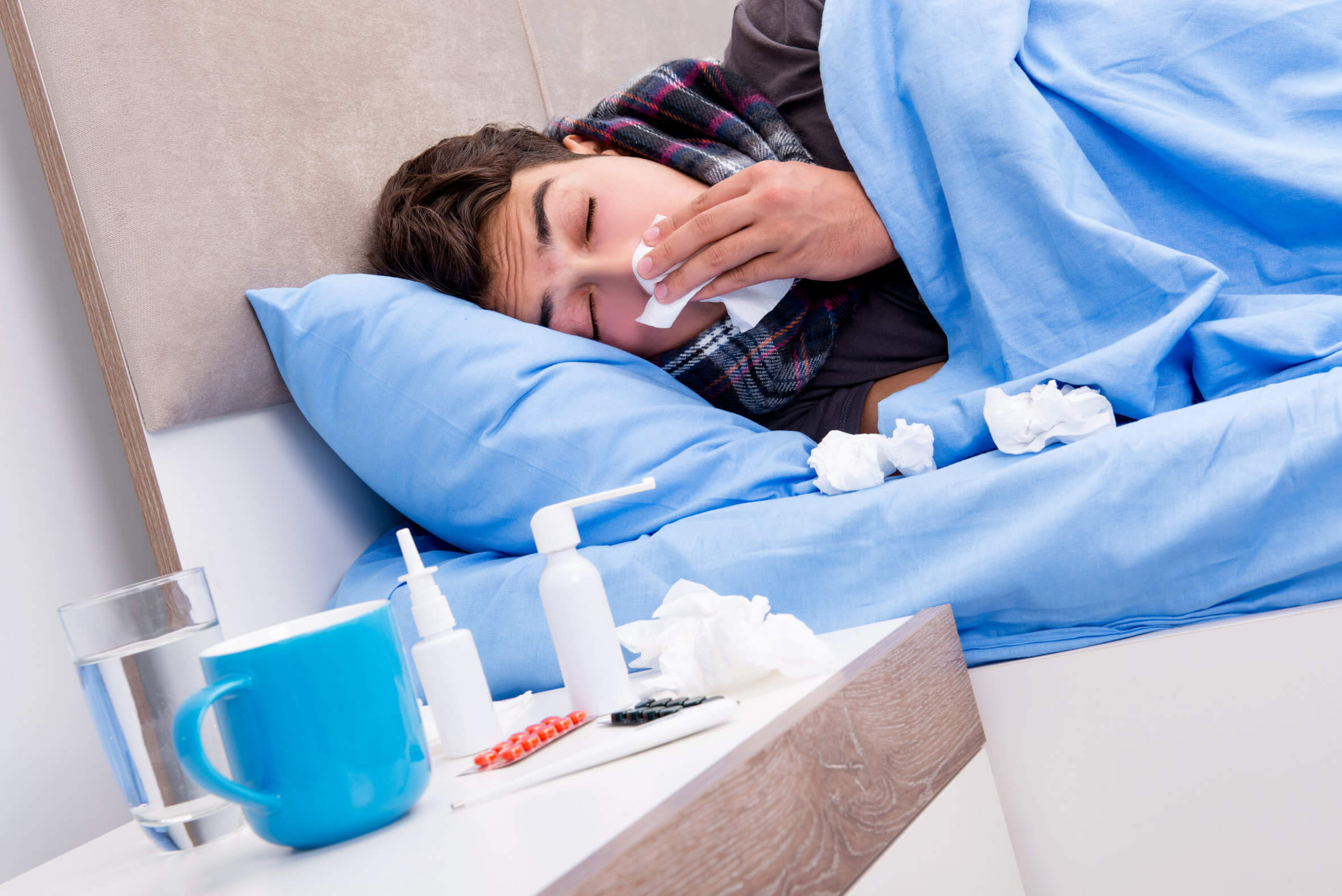 Sick ill man in the bed taking medicines and drugs